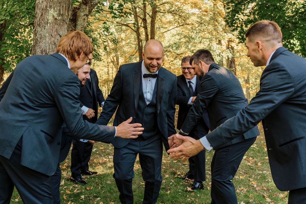 Groomsmen Shaking One Another's Hands For A Photo