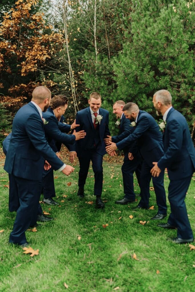 Groomsmen and Groom Dapping One Another
