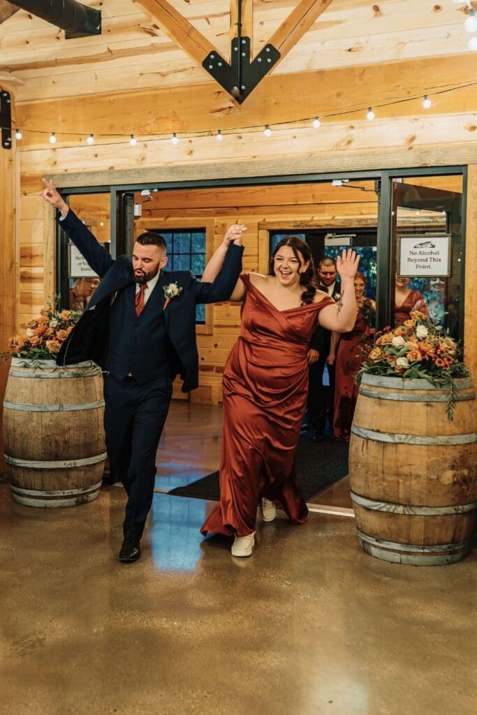 Groomsman and Bridesmaid Entering The Reception Area Happily