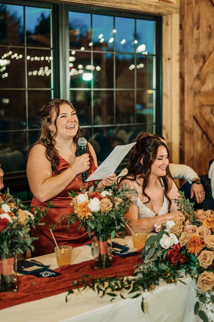 Bridesmaid Giving Her Speech Seated Beside The Bride