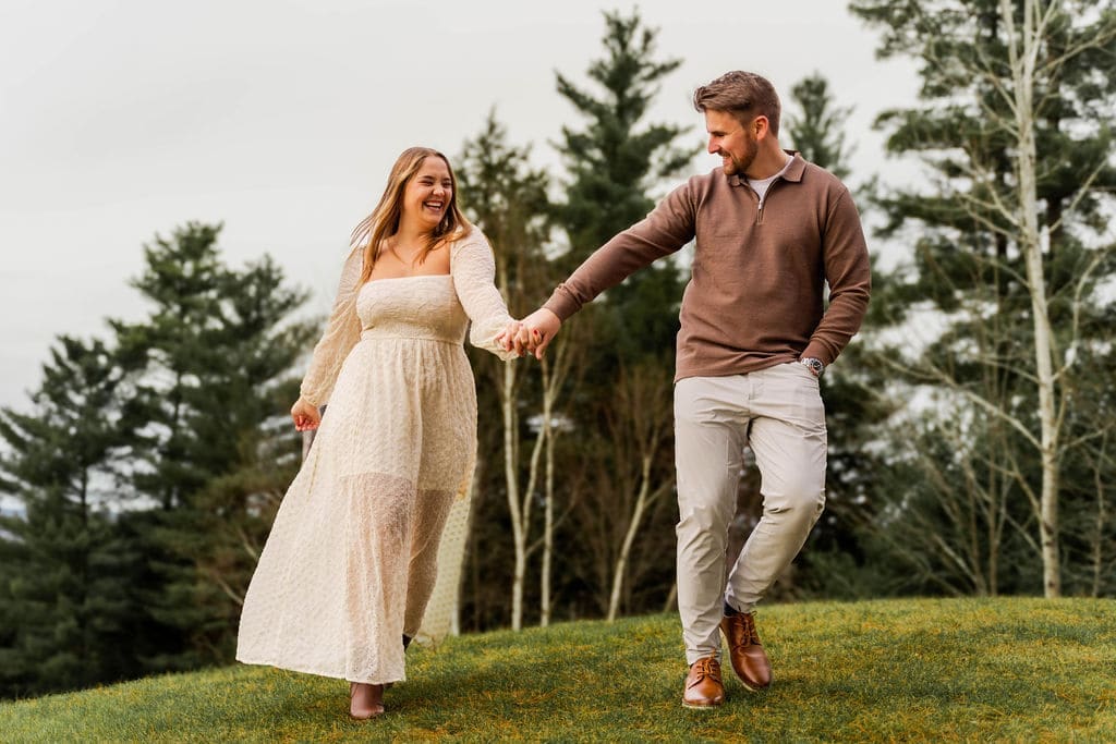 Engagement Photoshoot Of A Couple Holding Hands on A Hill