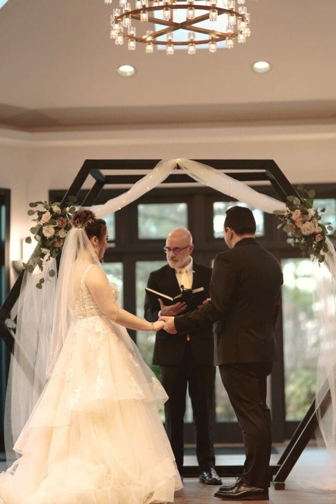 Indoor Wedding Ceremony With Couple And Officiant