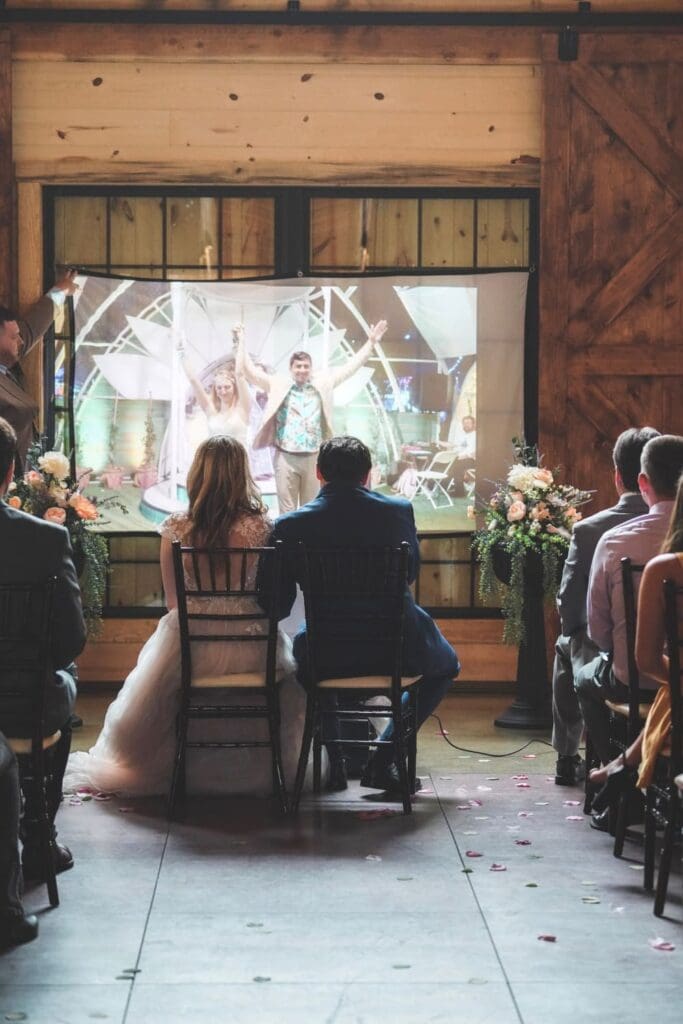 Couple Watching their Wedding Video During Reception