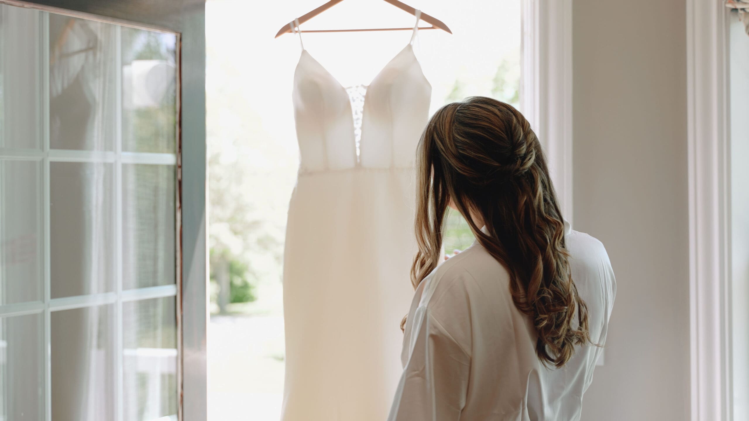 Bride Looking At Her Wedding Gown