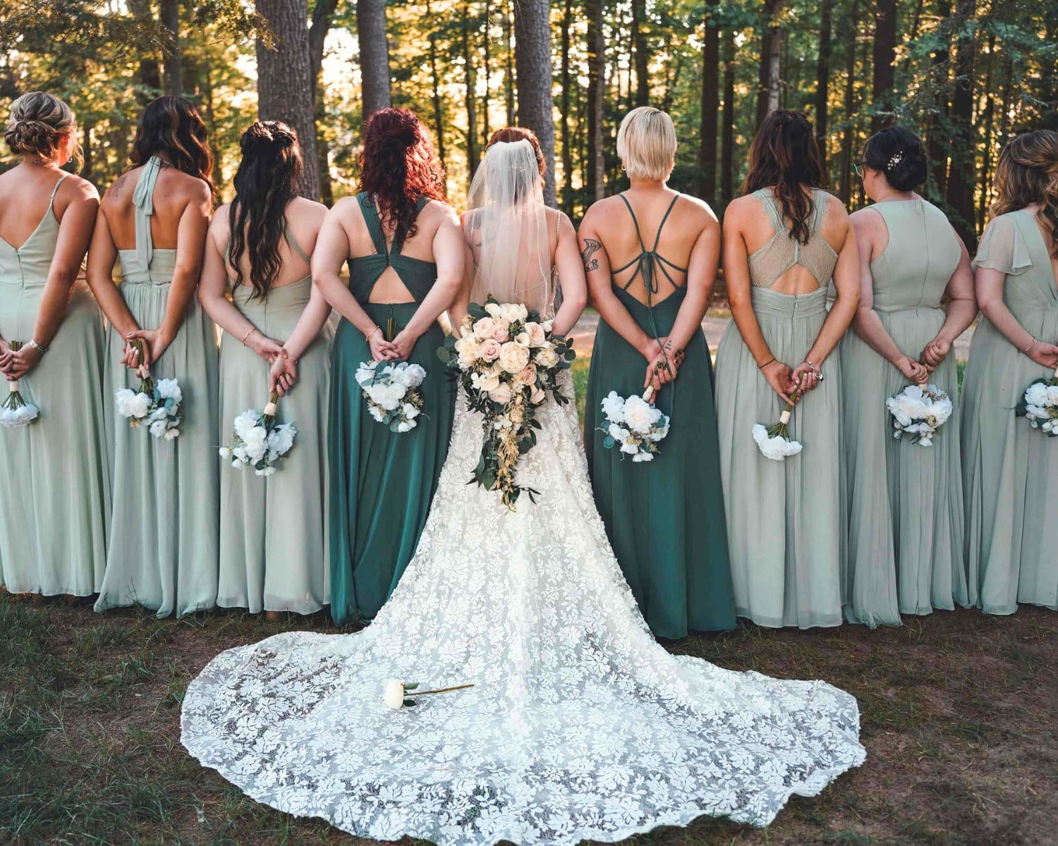 Bride and her bridesmaids with their backs turned against the camera