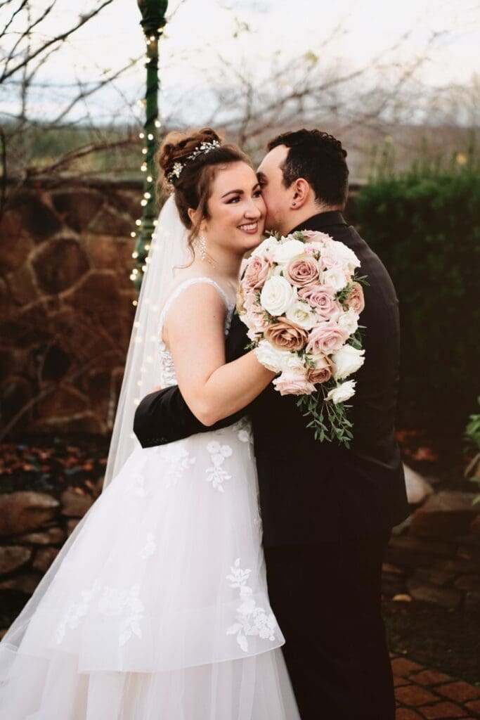 Bride and Groom Portrait with Woman Carrying a Bouquet and Facing the Camera