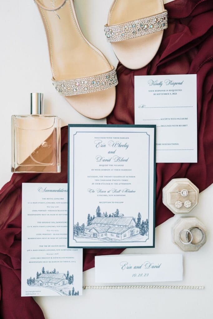 Wedding flatlay with invitation, a pair of heels, perfume, and other small items