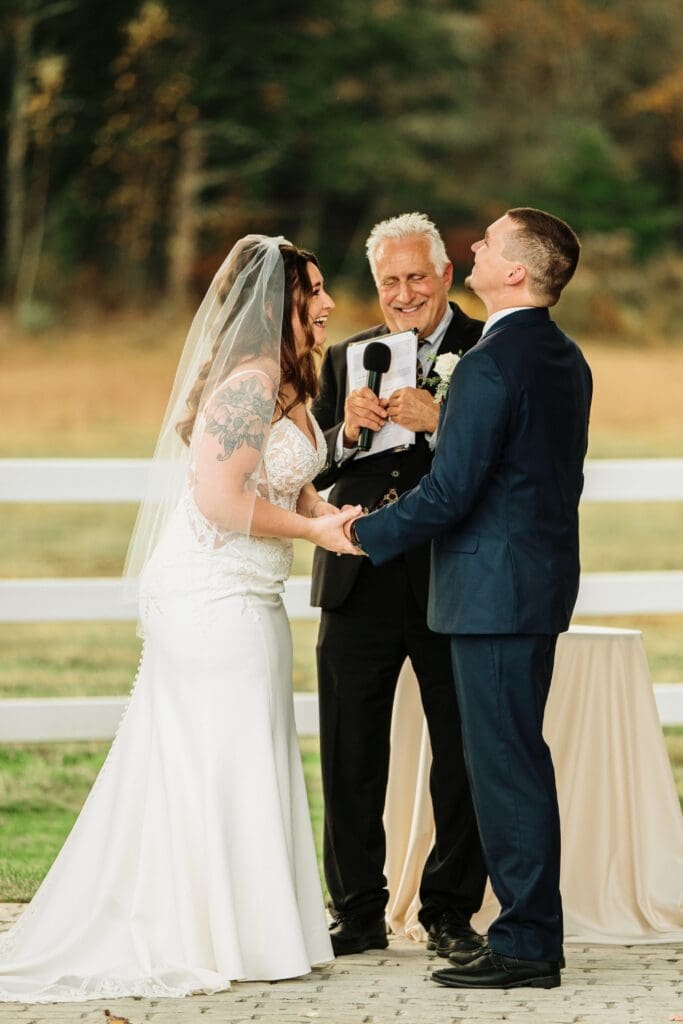 Bride, Groom, and Officiant In An Outdoor Wedding Ceremony