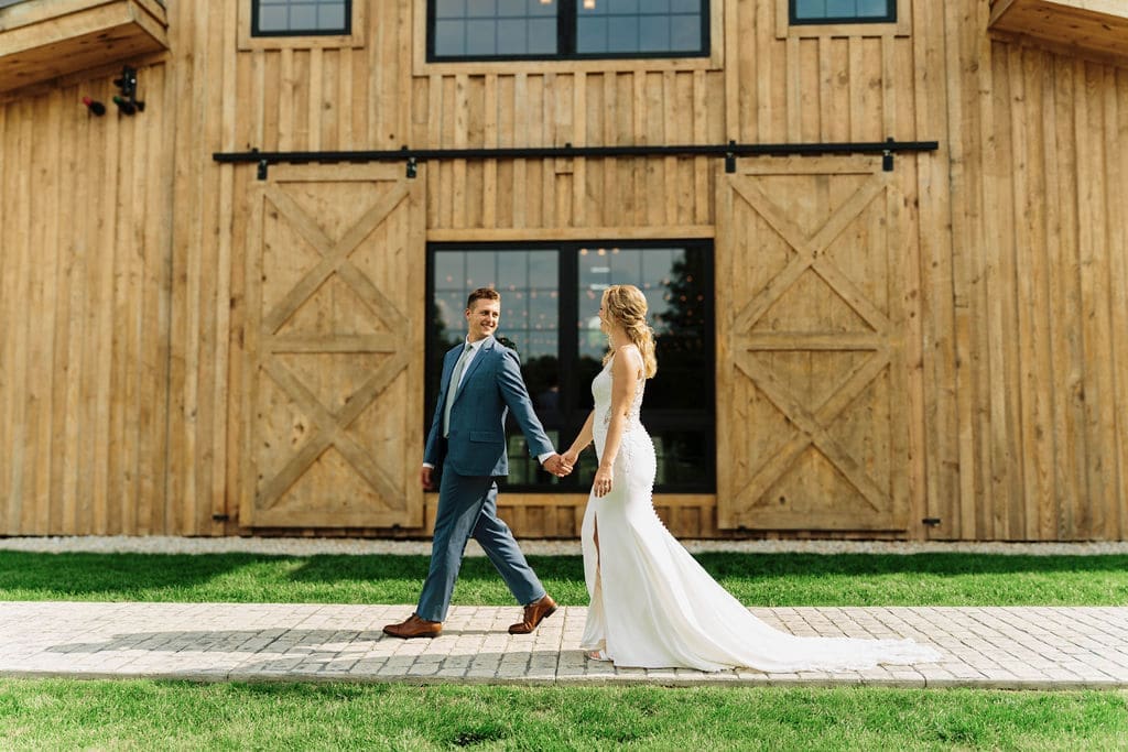 Couple Walking Side by Side In Outdoor Wedding Setting