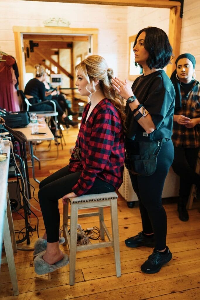 Wedding Hairstylist With Bride Sitting Down