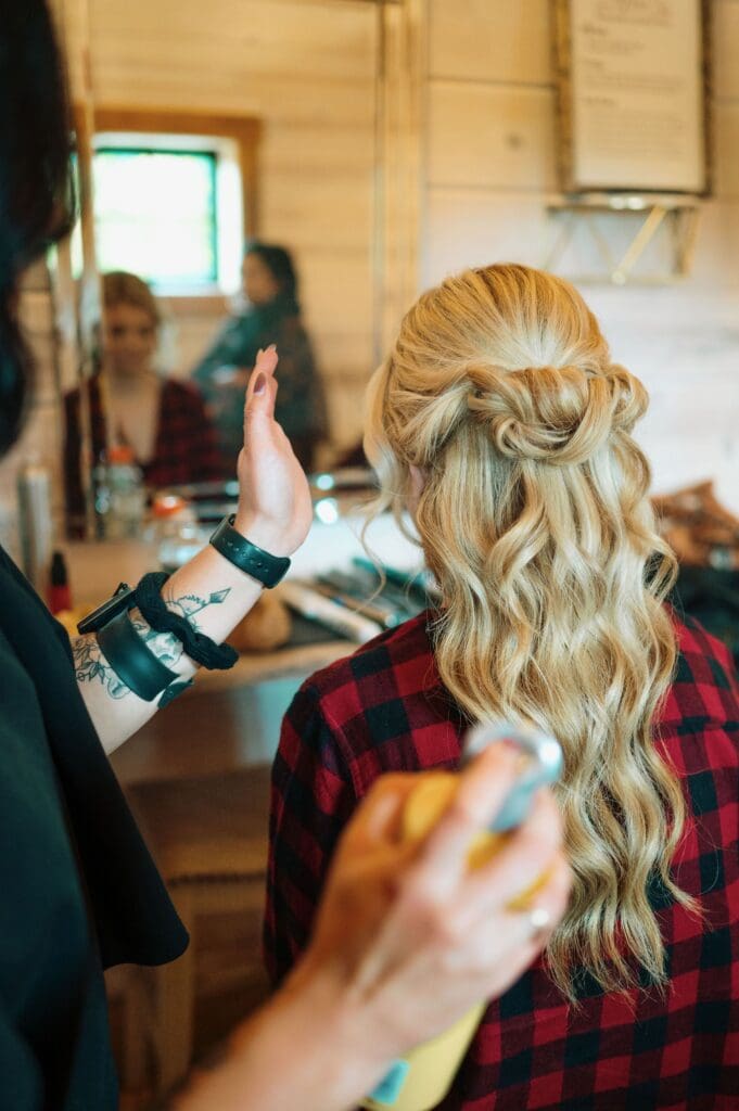 Bride's Hair Getting Touched Up By A Wedding Hairstylist