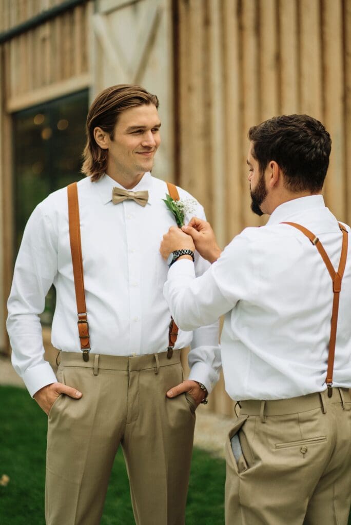 Groomsman Fixing Groom's Tie Outdoors