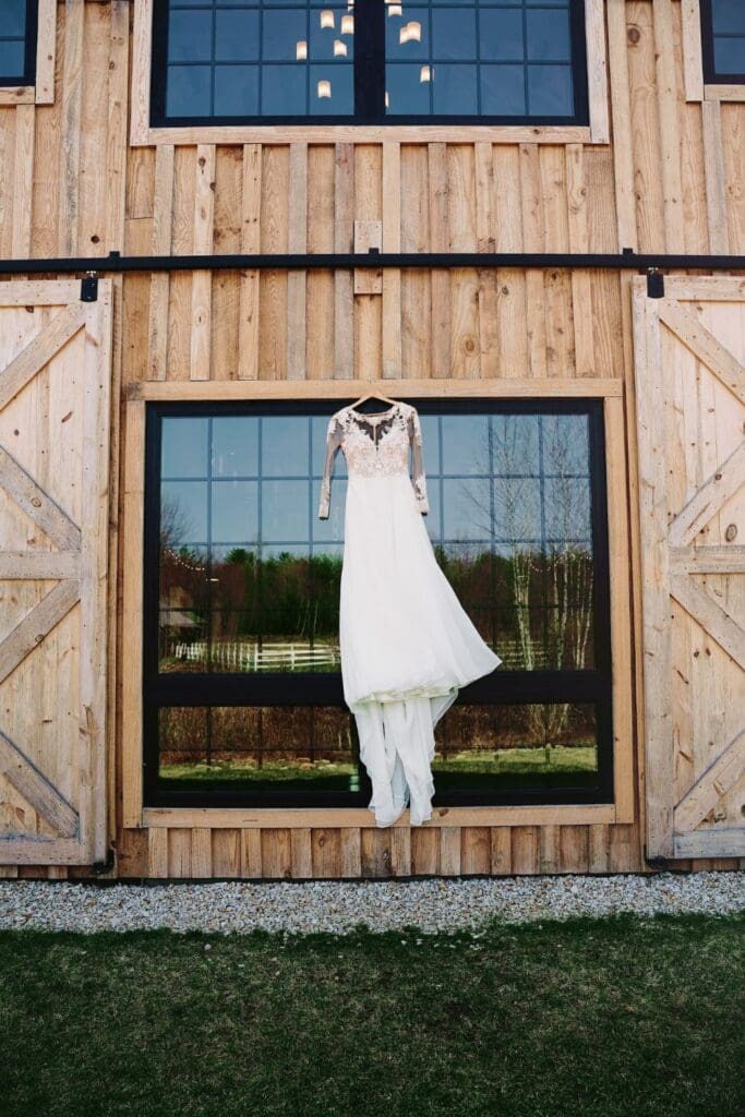 Creative Shot of Wedding Gown Hanging In The Wedding Venue