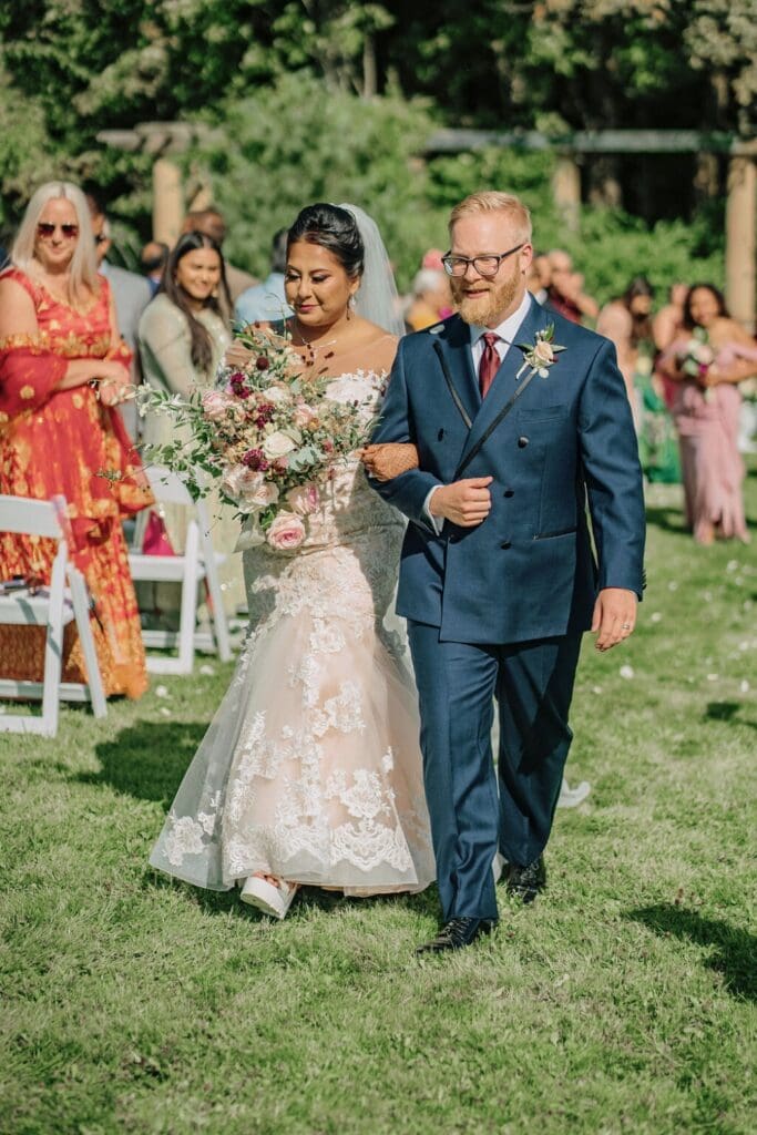 Couple Walking Down The Aisle in A Spring Wedding